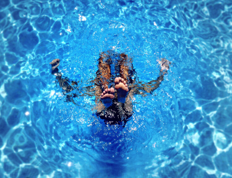 Pool technician servicing a crystal clear pool in Pensacola